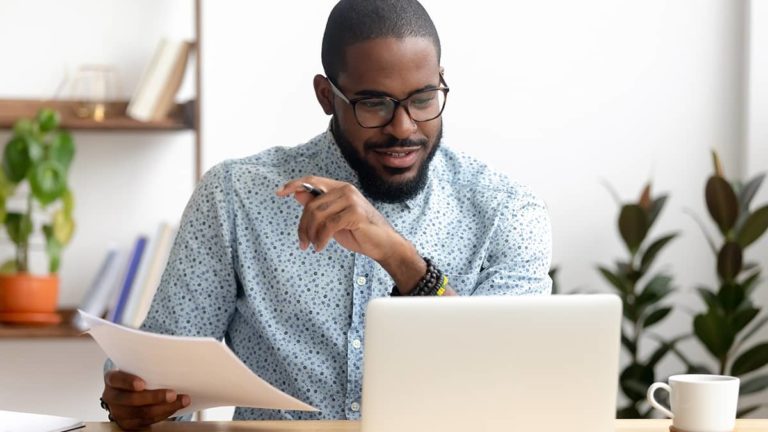 Man posting journal entries to the general ledger online.